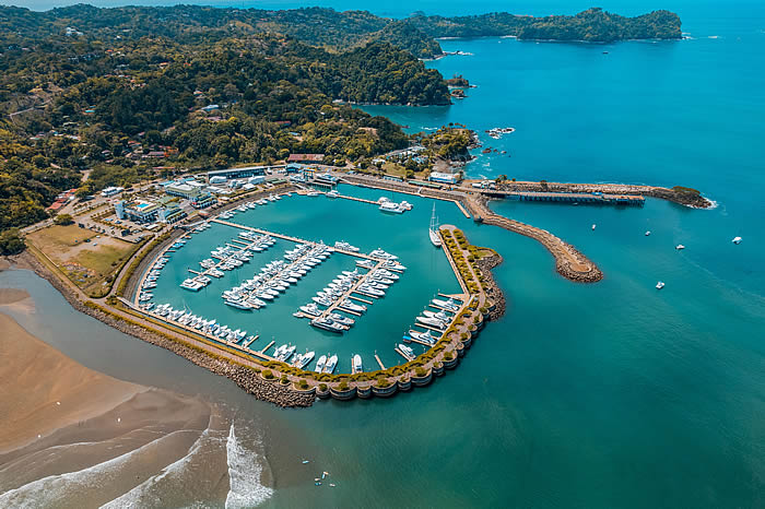 Costa Rica Global Development, marina in Quepos showcasing moored boats and vibrant blue waters
