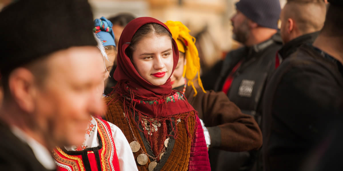 Gender Gap Bulgaria, Gender Equality, Bulgarian woman in traditional costume at an outdoor festival in Pernik