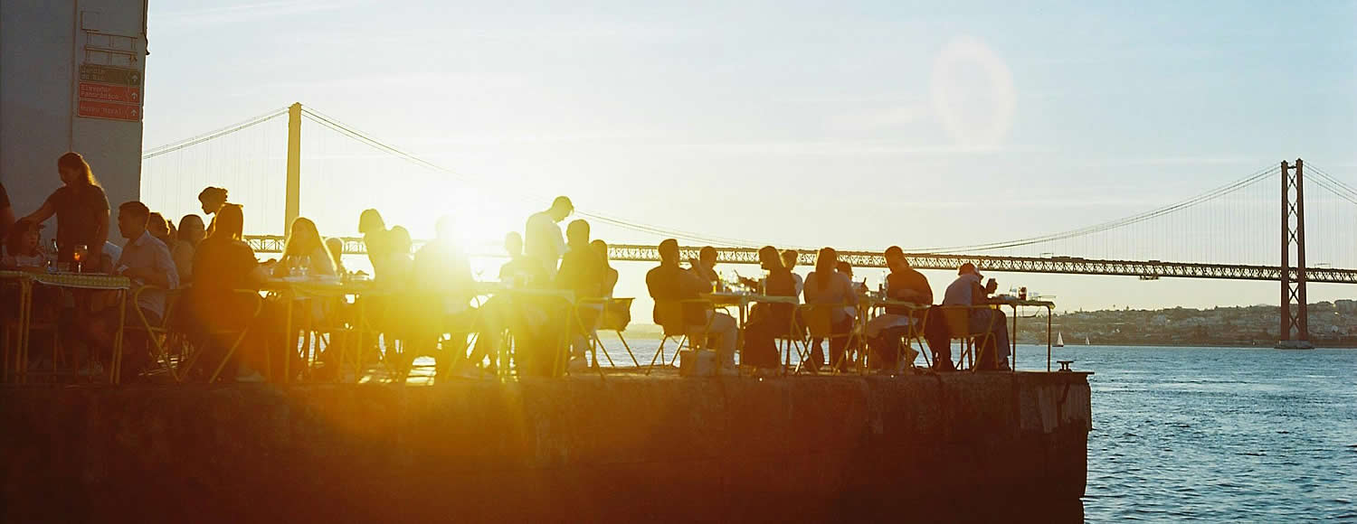 RYB Global Development, Connecting Citizens & NGOs Across 193 Countries, people sitting at cafe near a river