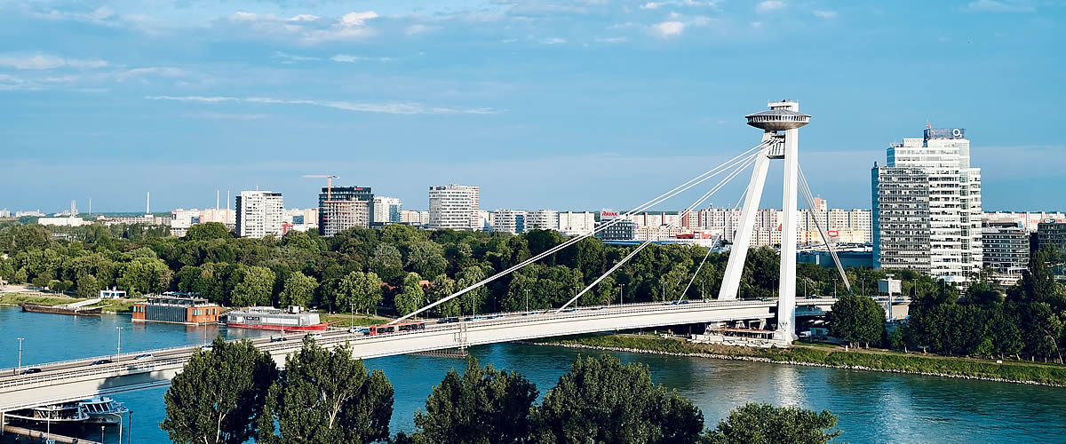 Slovakia Global Development, SNP Bridge crossing the Danube River with Bratislava cityscape