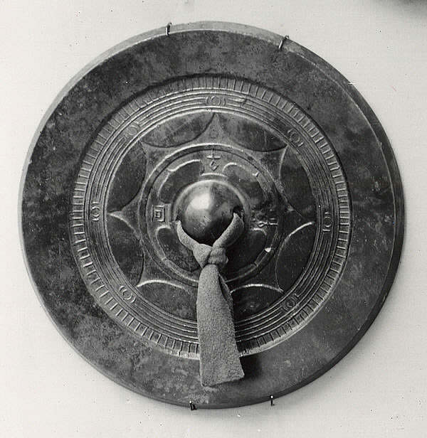 Mirror with Eight-Point Design, Han dynasty bronze mirror with silk cord through the central boss, 1st century, from The Metropolitan Museum of Art